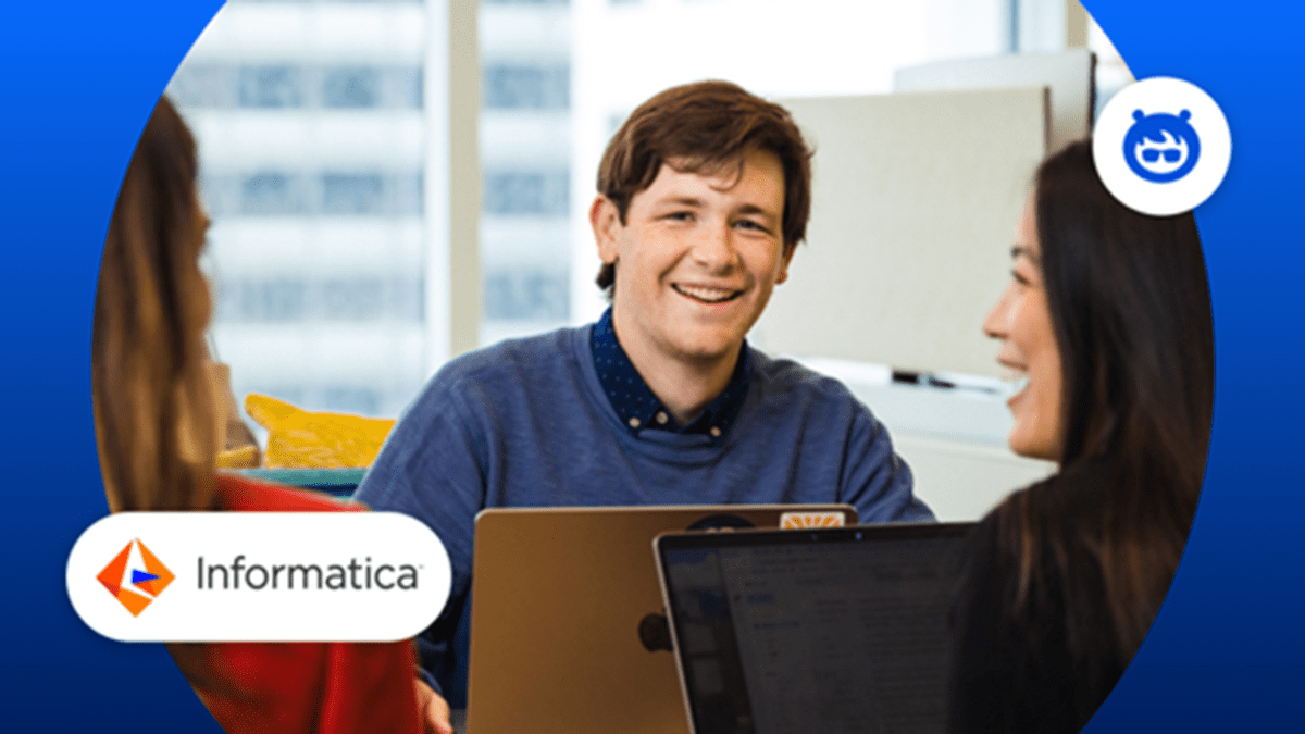 An image of employees enthusiastically working with Salesforce and Informatica’s logos on each side of the image