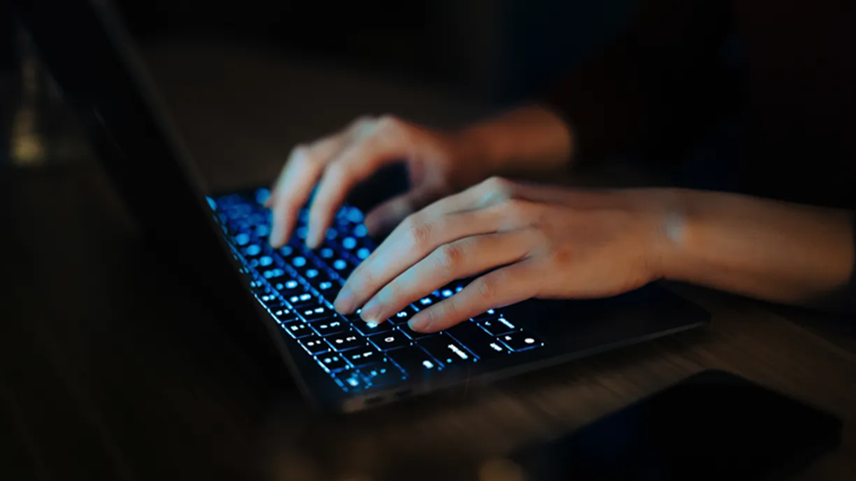 A pair of hands typing on a keyboard representing programmable connectivity