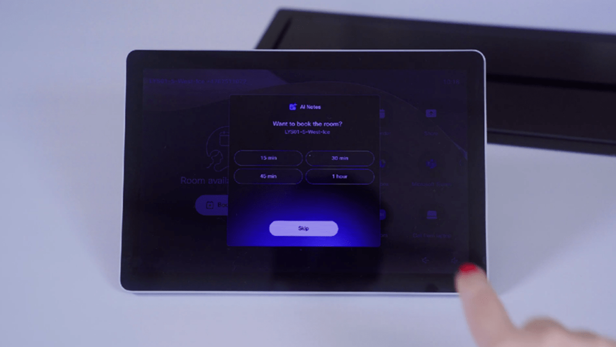 A person using a tablet to access Cisco RoomOS 26 AI Notes for scheduling a meeting room