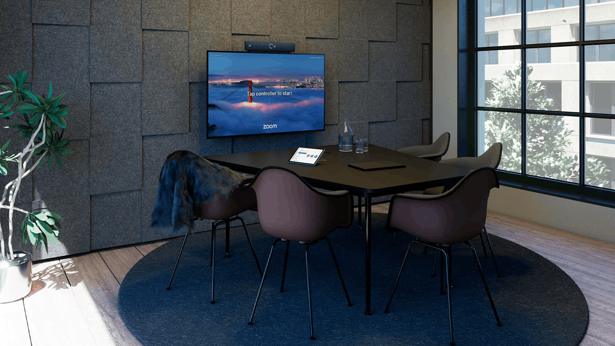 Modern meeting room featuring a Cisco collaboration device running a native Zoom Rooms interface with touchscreen controller and four-seat workspace