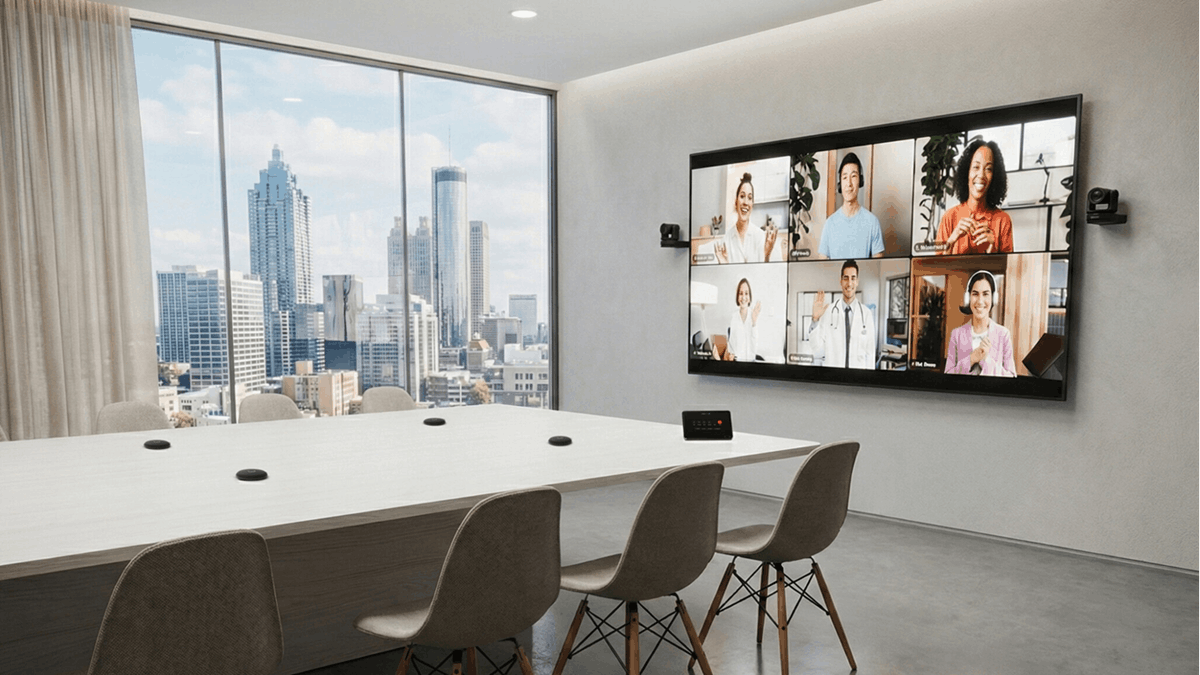 A modern conference room with large display showing hybrid video meeting powered by Cisco collaboration technology