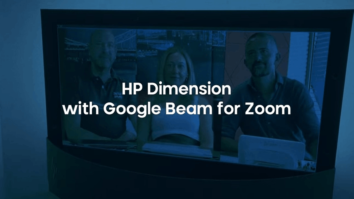 A display showing three people in a virtual meeting, with the text “HP Dimension with Google Beam for Zoom”