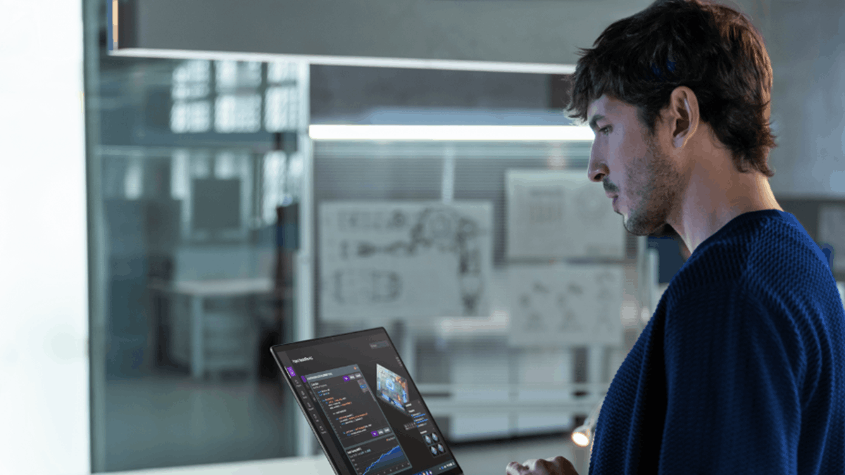 A person using an HP laptop displaying AI and creative software in a modern workspace
