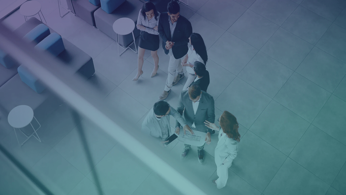 Overhead view of groups of people discussing in an office lounge area