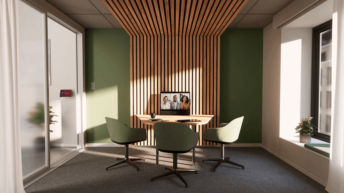 Small meeting room with video conferencing setup designed for hybrid collaboration