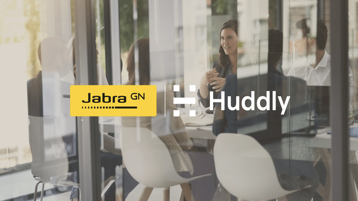 Jabra and Huddly’s logos with a background of employees conversing in a meeting room