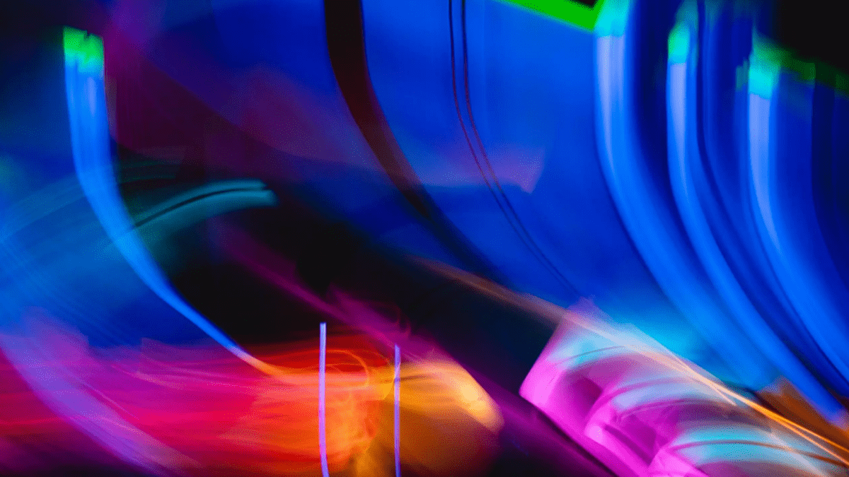 Streaks of light in blue, green, red, orange, and pink