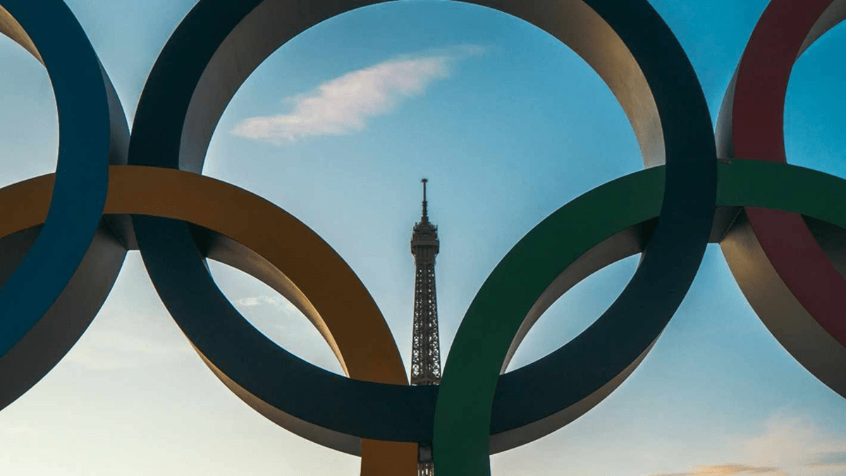 A view featuring the Olympic rings in front of the Eiffel Tower in Paris, France.