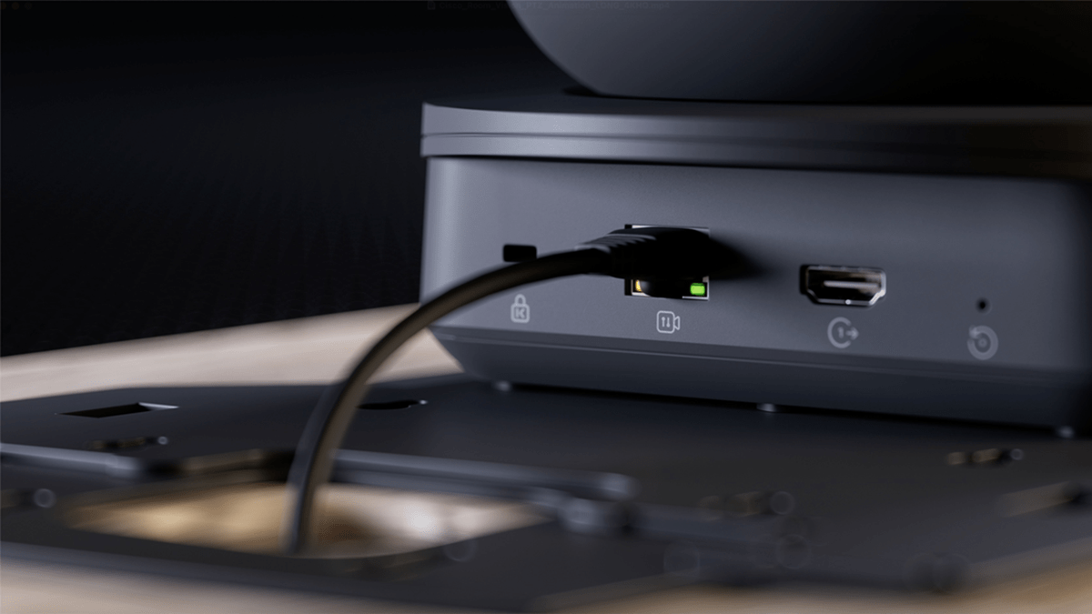 Close-up view of a Cisco Room Vision PTZ camera showing simplified AV deployment with a single Ethernet cable connected for power and video over IP
