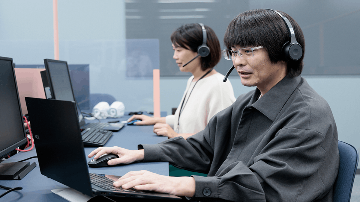 Customer service agents wearing headsets working at computers in a modern office environment