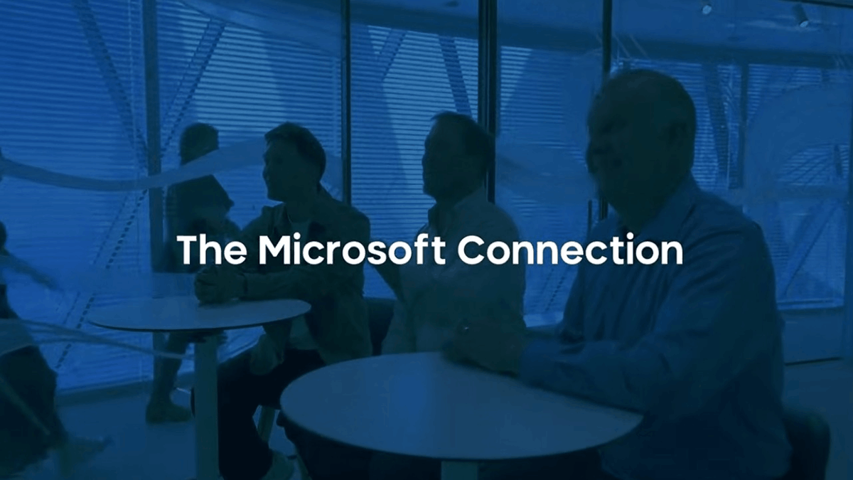 A collaborative workspace background with the text “The Microsoft Connection”