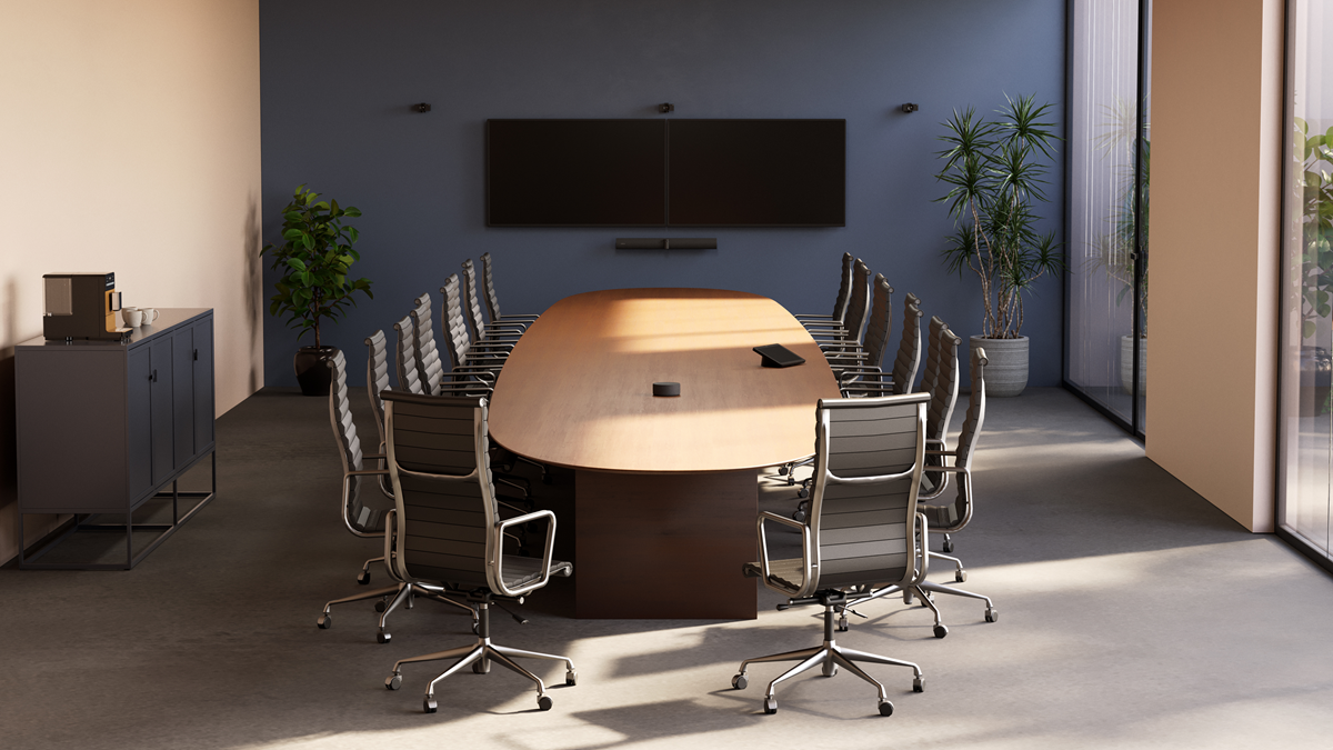 A conference room with a long table and seating, illustrating a mid-to-large meeting space designed for scalable video collaboration using Jabra PanaCast Room Kits