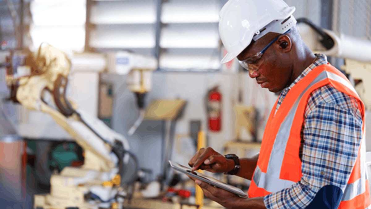 An industrial worker using the AT&T IoT Network Intelligence to consolidate performance monitoring, analytics, and security