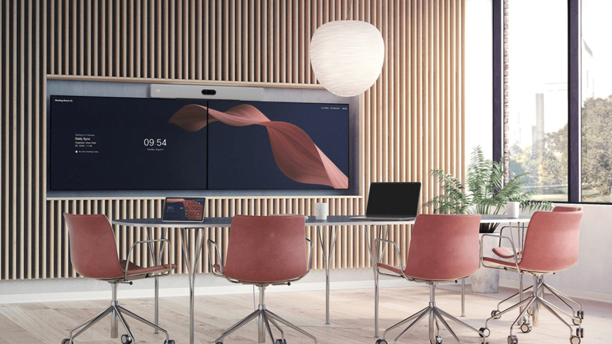A meeting room featuring RoomOS 26
