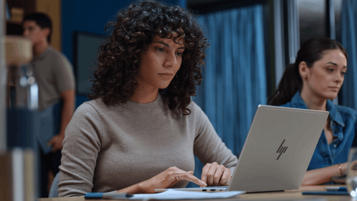 A professional working on an HP laptop highlighting AI PC productivity in modern hybrid work environments