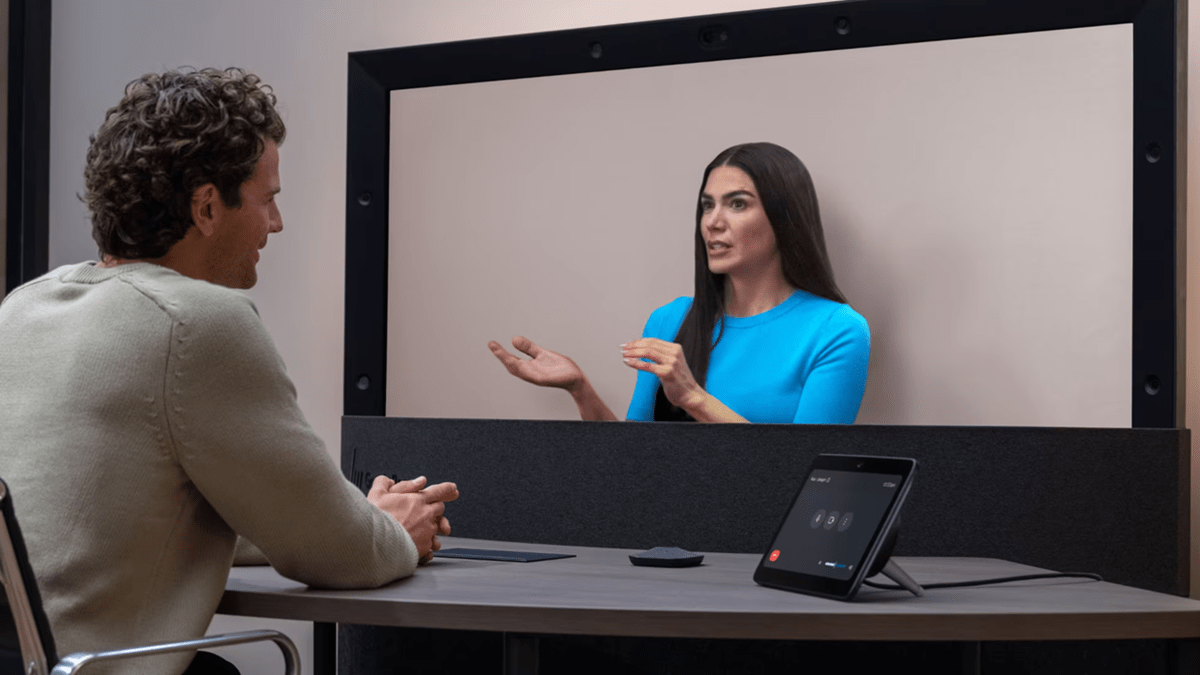 A man and a woman engaging in a virtual meeting using HP Dimension with Google Beam