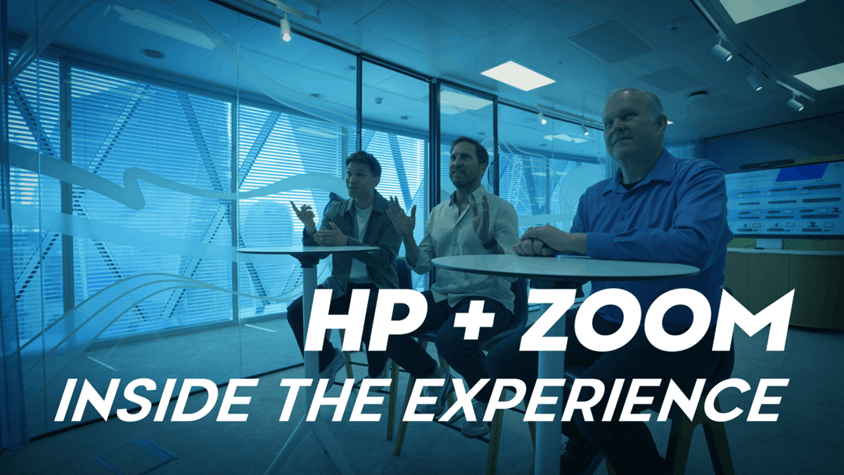 Three people seated in a collaborative workspace with the text “HP + Zoom Inside the Experience”