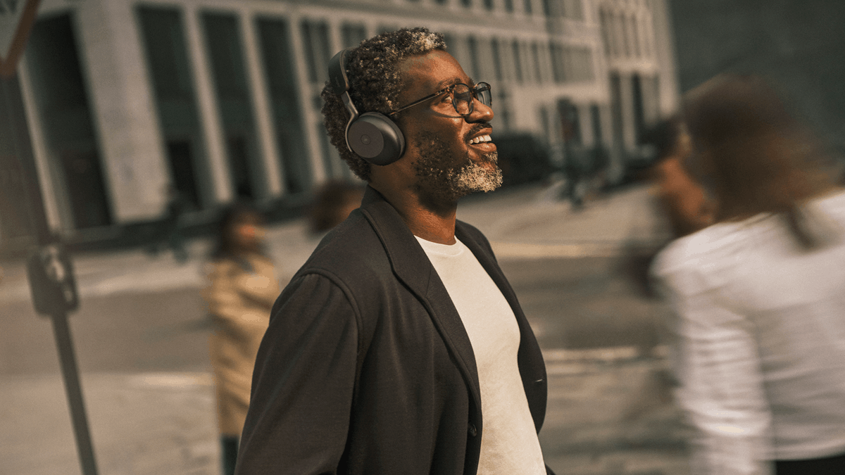 A man walking in the streets, wearing the Jabra Evolve3 75