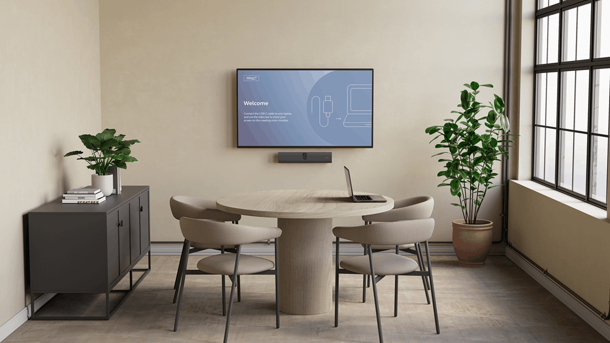 Small meeting room with Jabra PanaCast U30 video bar mounted below a display showing BYOD connection instructions